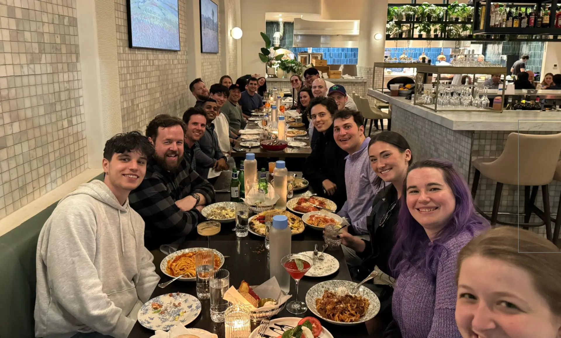Skydog team sharing a long dinner table at a team summit